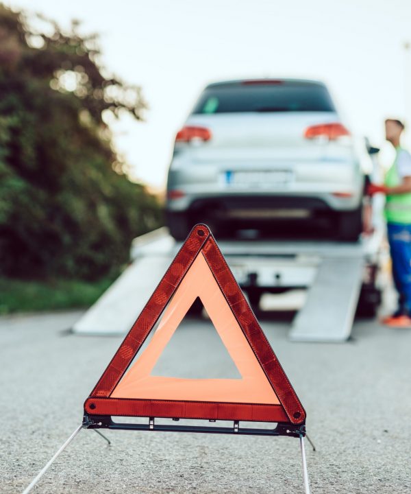 Handsome middle age man working in towing service on the road. Roadside assistance concept.