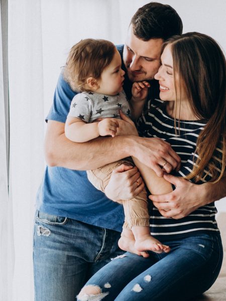 Young family with their little son at home